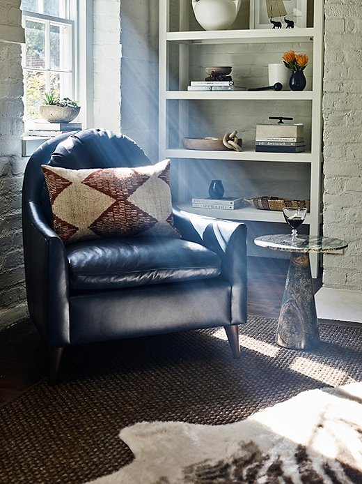 With its simple but gracefully curved silhouette, the Lowell Leather Chair subtly introduces Southwestern texture to a room. So does the Continental Jute Rug beneath the faux hide (and of course, the faux hide itself). 
